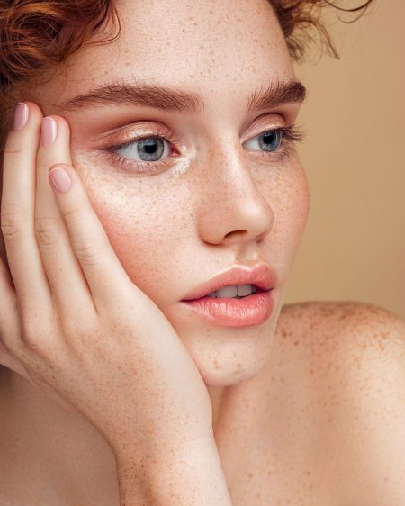 A Woman With Freckles And Clear Facial Skin