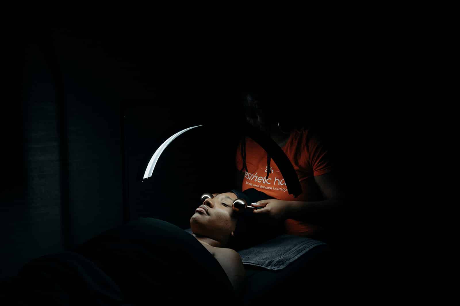 a man holding a phone in a dark room